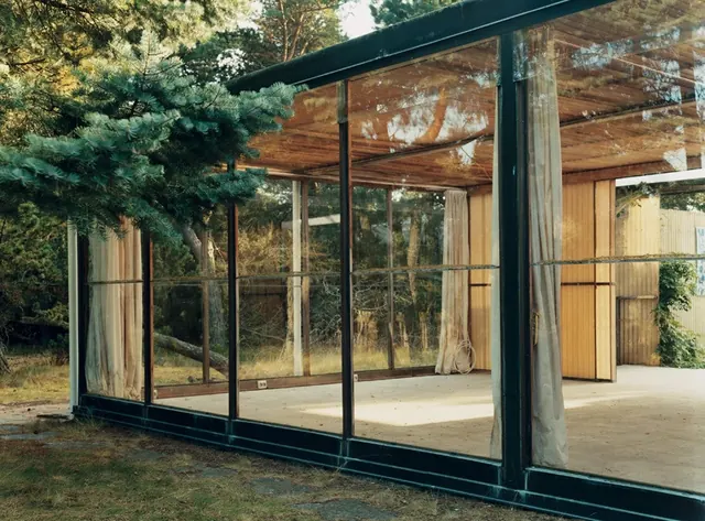 Abandoned modernist house with glass walls, minimal, photographic, earthy