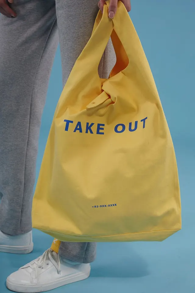 Yellow take-out tote bag, photographic, minimal, warm
