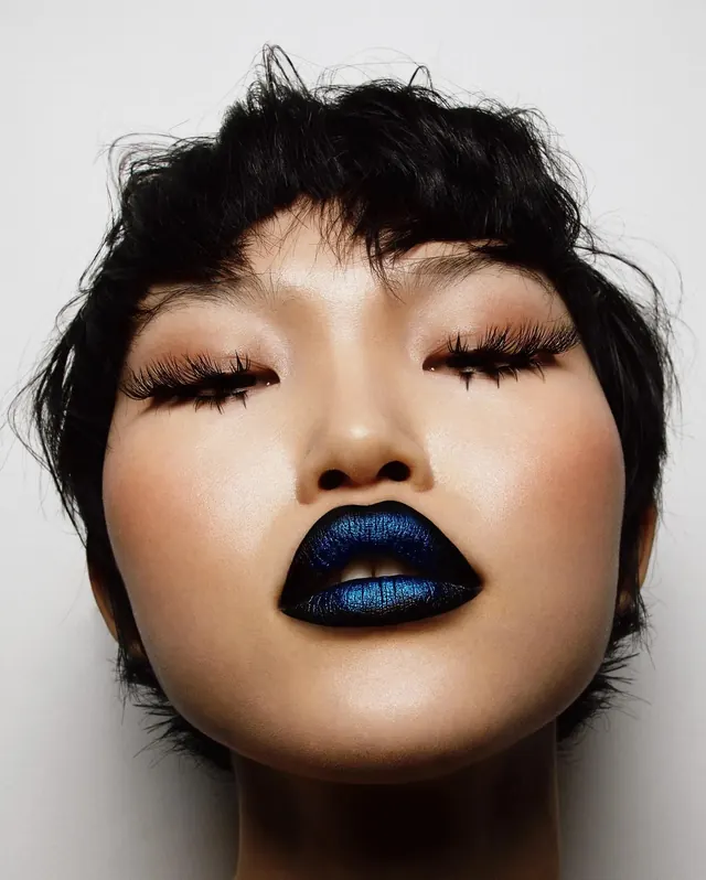 Blue lipstick makeup close-up, photographic, editorial, dark