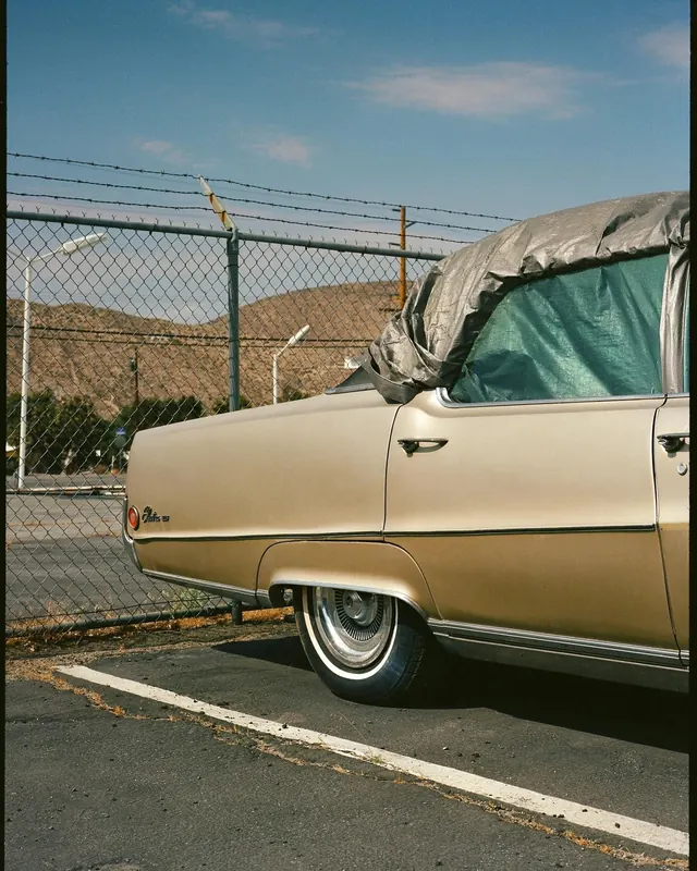 Vintage Pontiac parked by fence, photographic, retro, muted