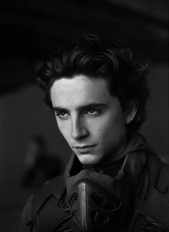 Dramatic black and white portrait of young man in armor, editorial, photographic, monochrome