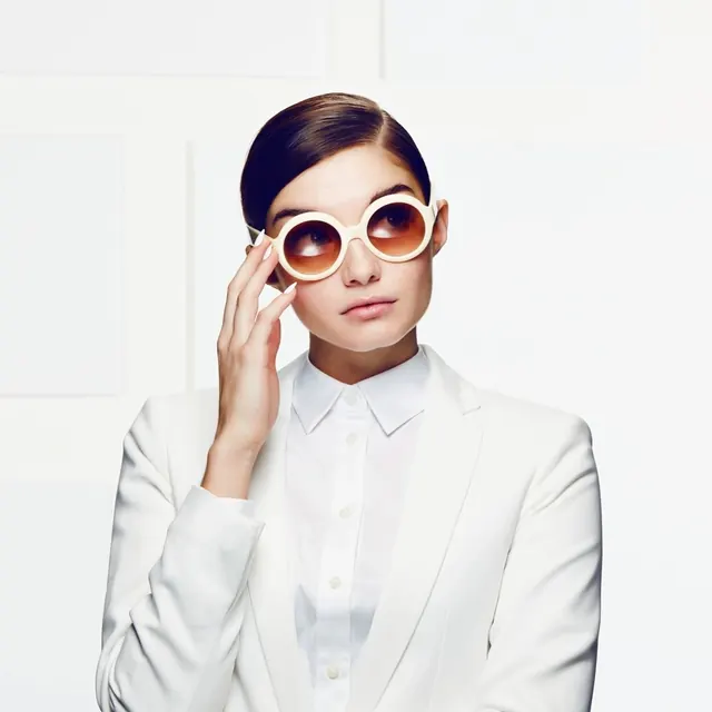 Woman in White Suit with Sunglasses