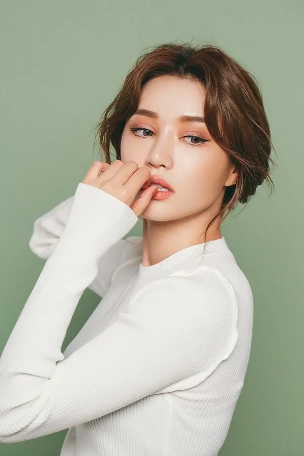 Portrait of a woman in white knitwear