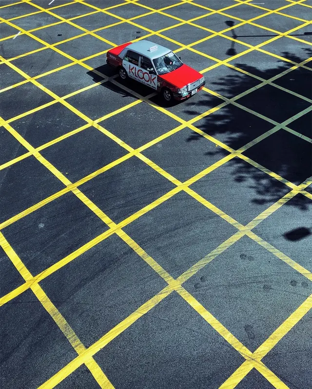 Red Car on Yellow Grid