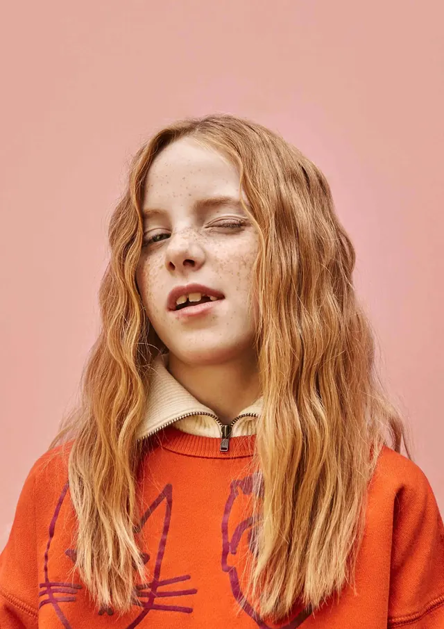 Portrait of a woman in orange knitwear
