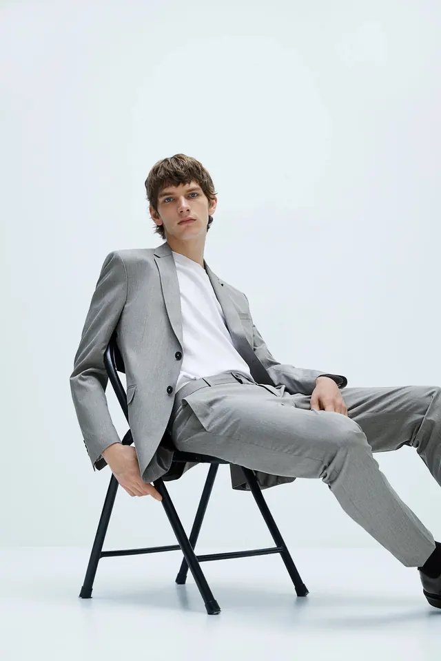 Man in Grey Suit Sitting on Stool
