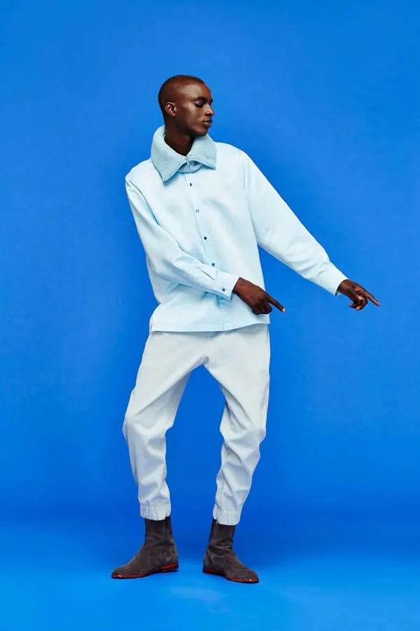 Man in Light Blue Suit against Blue Background