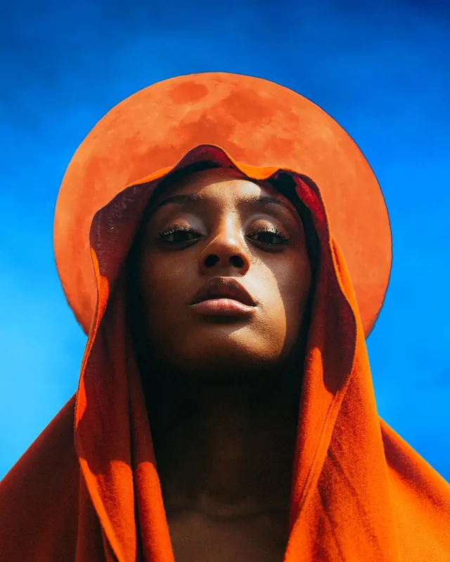Portrait of a person in orange headwear