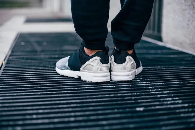 Sneakers on Grated Surface