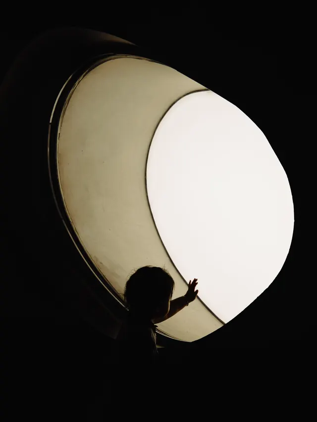 Silhouette against glowing orb