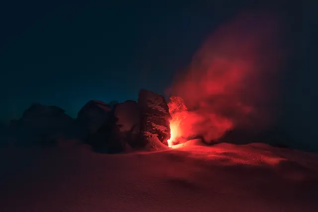 Red Glowing Cave in Snowy Landscape