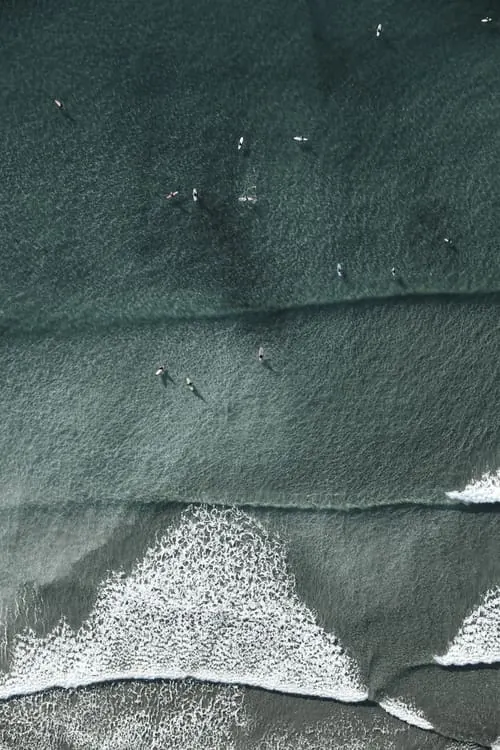 Aerial waves with surfers, photographic, minimal, dark