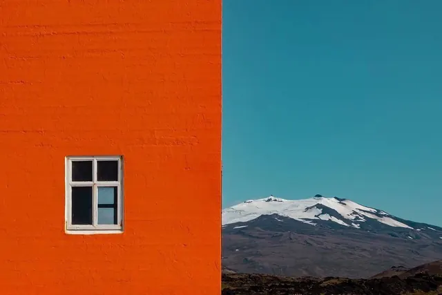 Orange Building and Snowy Mountain Landscape