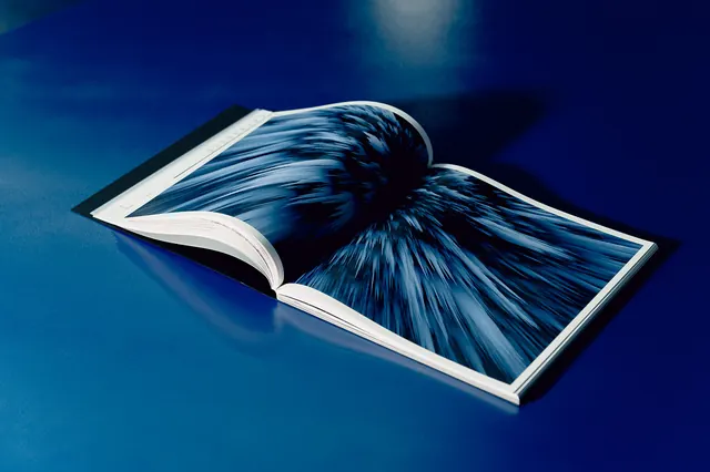 Open Book with Blue Abstract Graphic