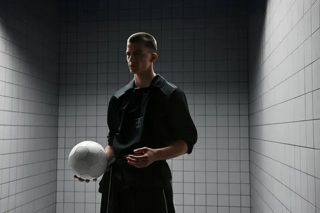 Man in Tiled Room with Sphere