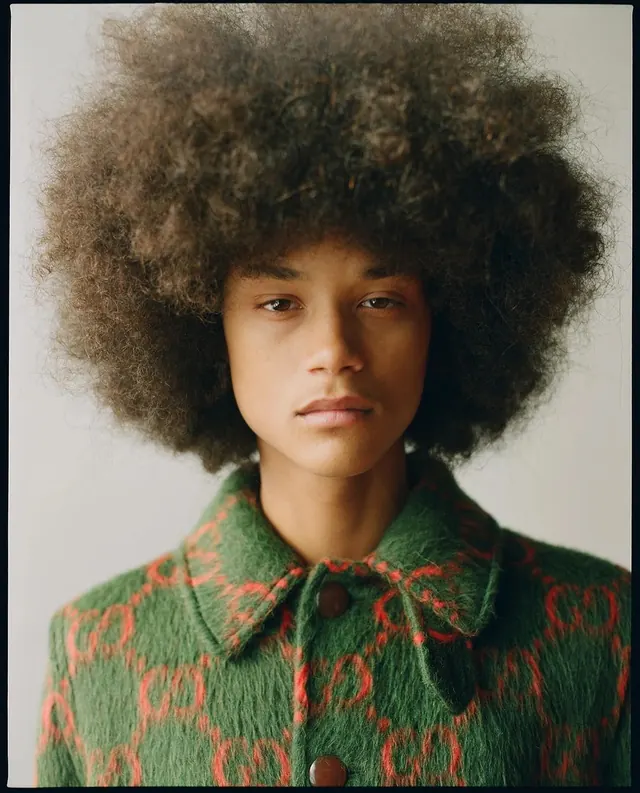 Portrait of a woman with afro hair in patterned shirt