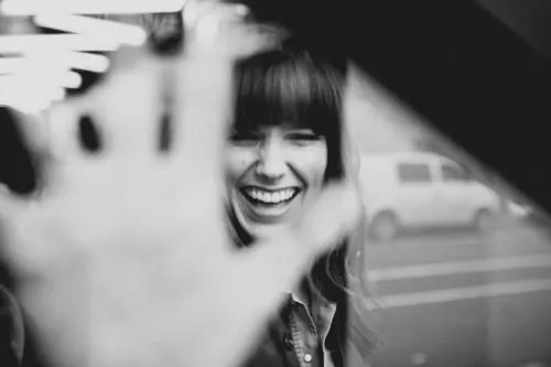 Laughing woman pressing hand to glass, photographic, monochrome, monochrome