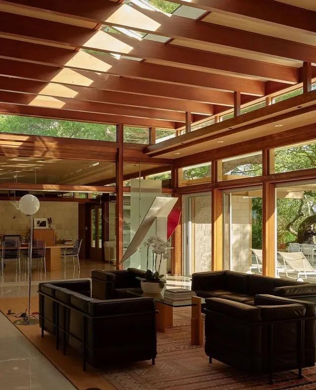 Sunlit modern living room with wood beams, photographic, warm
