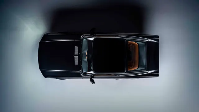 Top-down view of black luxury sedan, photographic, minimal, dark