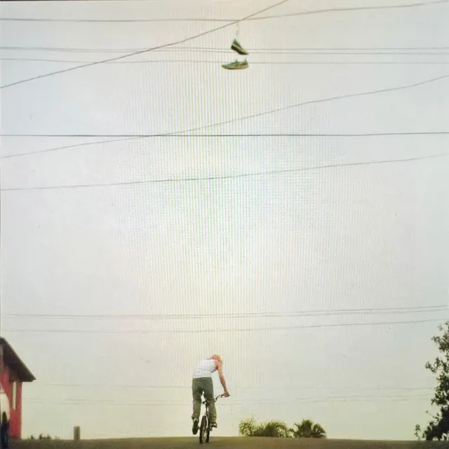 Person on Bicycle under Power Lines