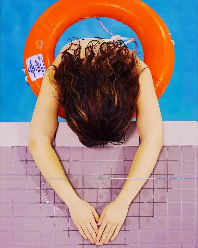 Person in Pool with Orange Tube