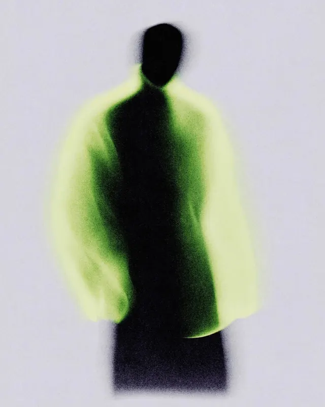 Blurred Human Figure in Green