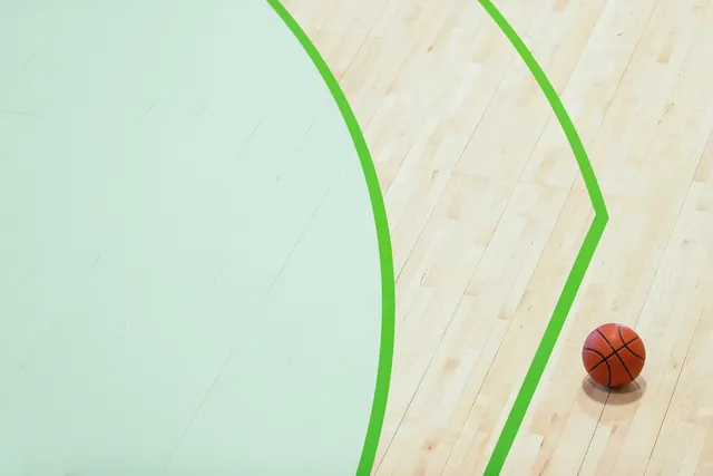 Light wood floor with green lines and basketball, minimal, photographic, light