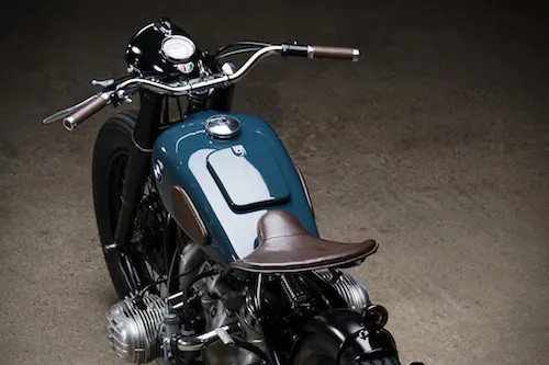 Vintage teal motorcycle product shot, photographic, minimal, dark