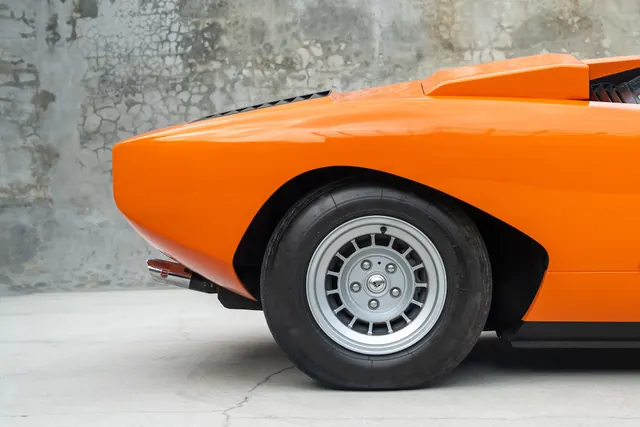 Orange vintage car profile, minimalist, photographic, vibrant
