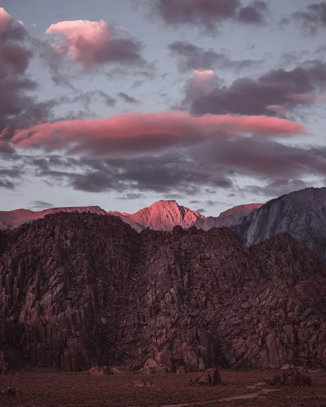 Landscape photography of mountains at sunset with dramatic pink sky, photographic, editorial, warm