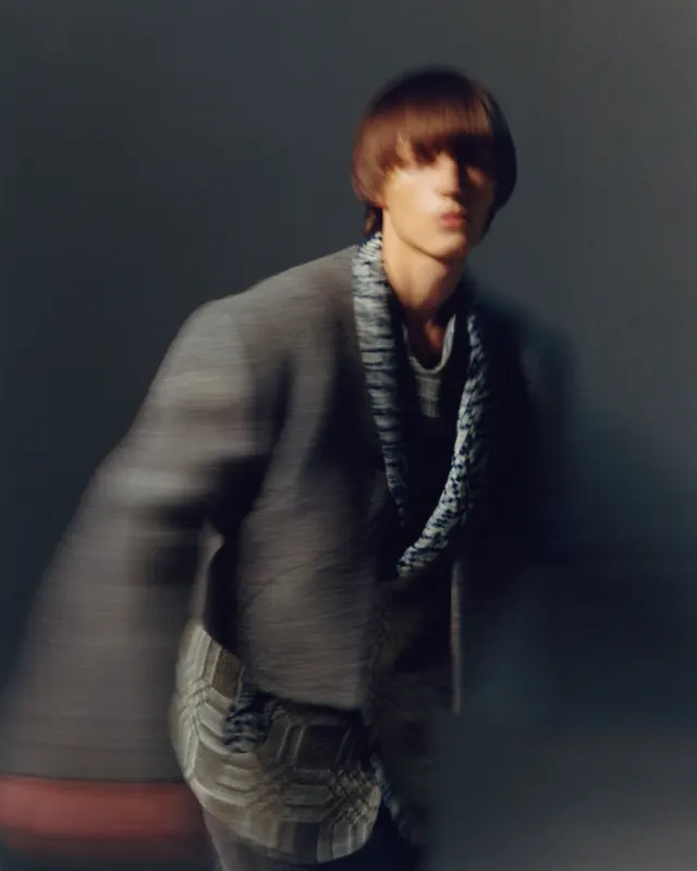 Dark studio portrait with warm accent lighting, photographic, dark-mode, dark