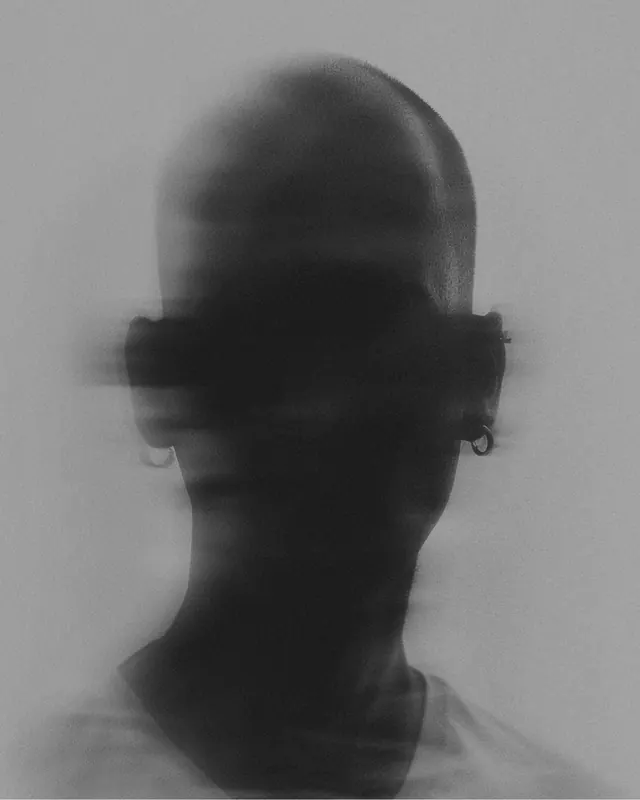 Silhouetted profile head with blindfold, photographic, minimalist, dark