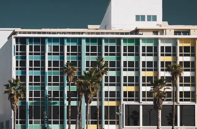 Brutalist building facade with colored windows, brutalist, photographic, dark