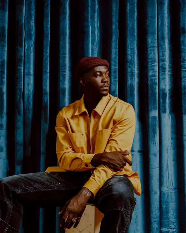 Portrait against corrugated blue backdrop, photographic, warm, warm