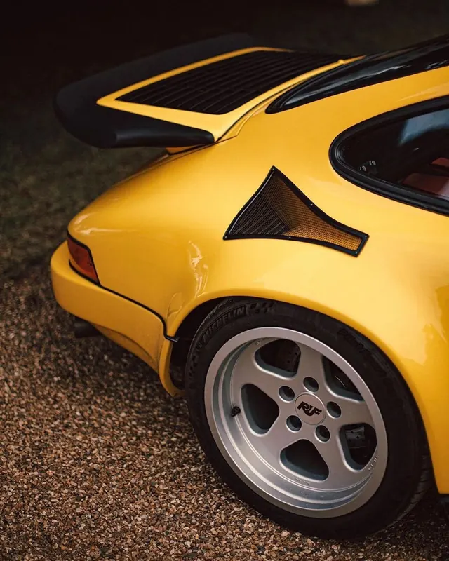 Yellow sports car detail with carbon fiber accents, photographic, technical, warm