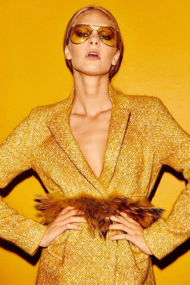 Fashion portrait in golden monochromatic styling, light-mode, photographic, warm