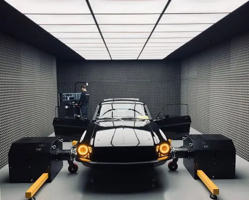 Car in service garage with yellow parking blocks, dark-mode, technical, dark