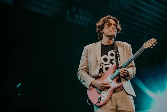 Musician on stage with electric guitar, photographic, dark-mode, cool