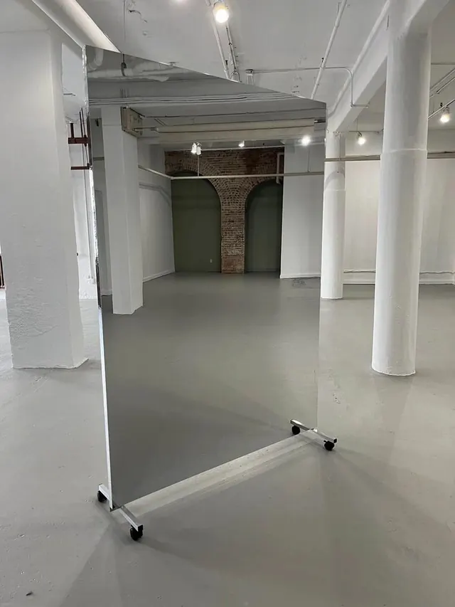 Industrial warehouse loft space with white columns, brutalist, minimal, monochrome
