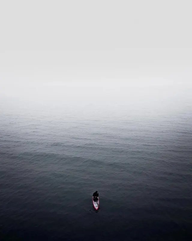 Minimalist person in ocean, photographic, minimal, cool