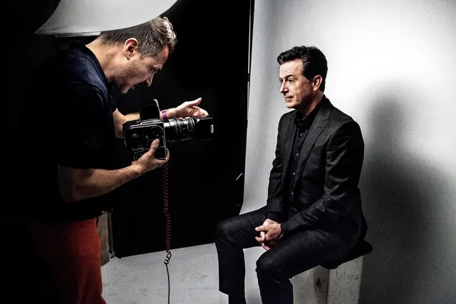 Photography studio shoot with cameraman and subject, photographic, technical, dark