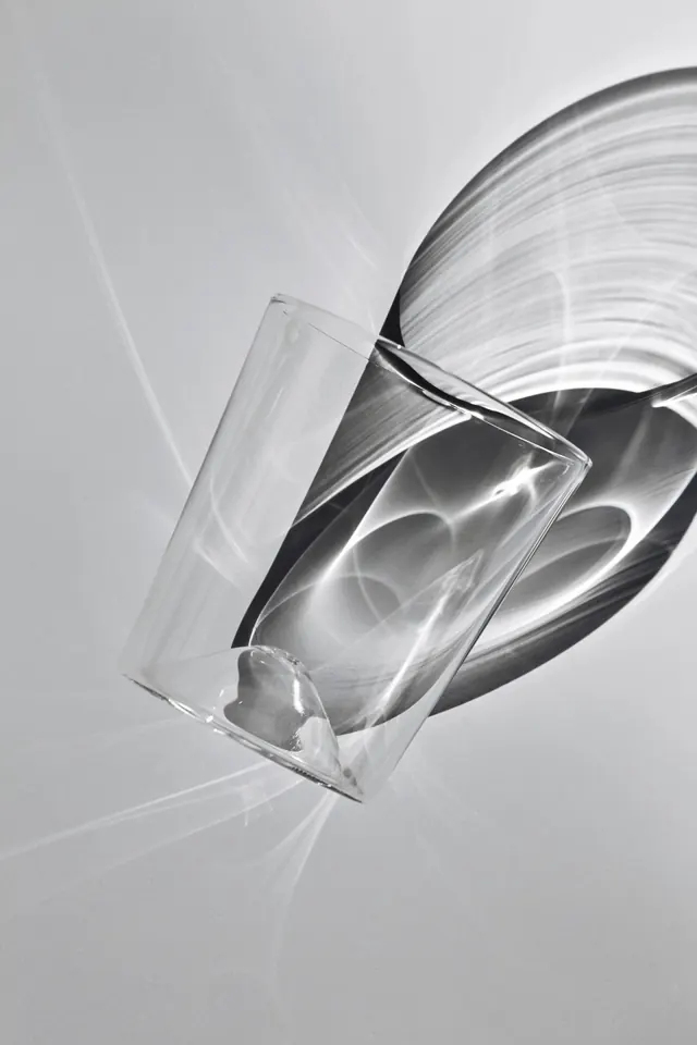 Glass vessels with flowing liquid motion, photographic, minimalist, monochrome