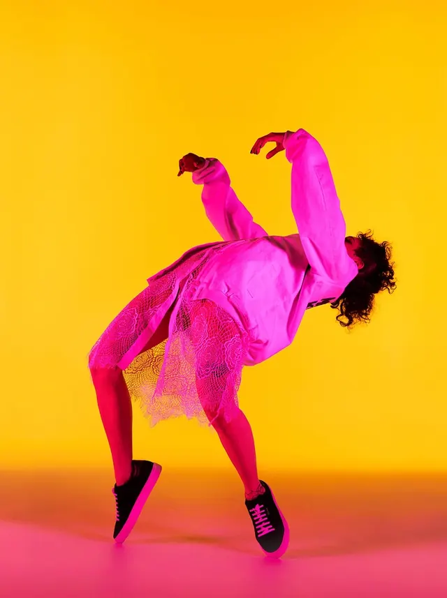Figure in magenta athletic wear against gradient background, photographic, gradient-heavy, vibrant