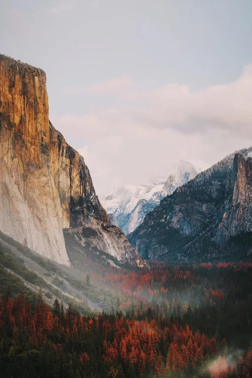 Mountain valley landscape with golden light, photographic, editorial, warm