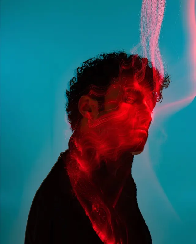 Double-exposed portrait with neon red and teal, photographic, gradient-heavy, vibrant