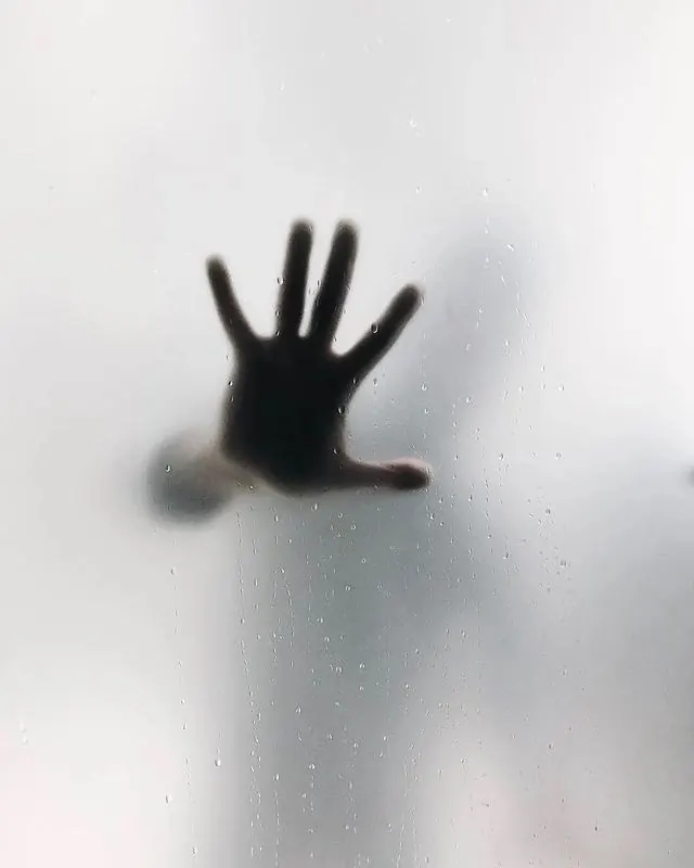 Hand against frosted glass, photographic, minimalist, light