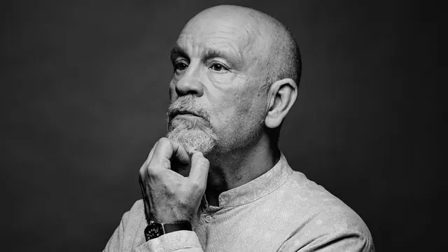 Portrait, man with watch, contemplative pose, photographic, minimalist, dark