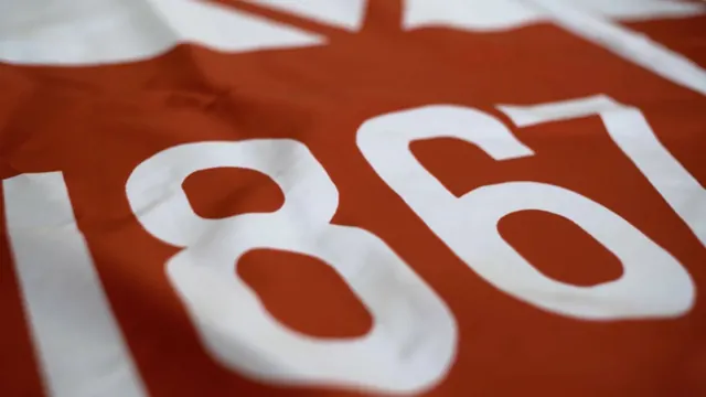Close-up of embossed "1867" numerals, photographic, minimal, warm