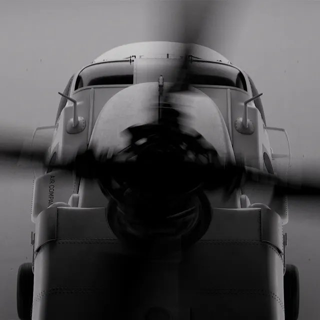 Vintage airplane nose with spinning propeller, photographic, monochrome, monochrome