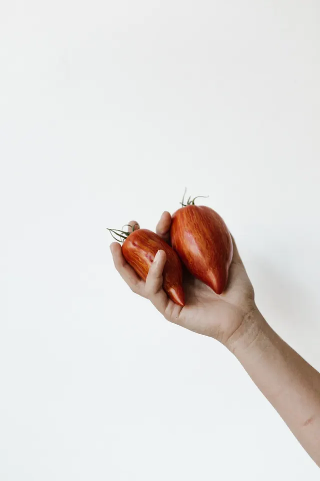 Hand Holding Red Fruit